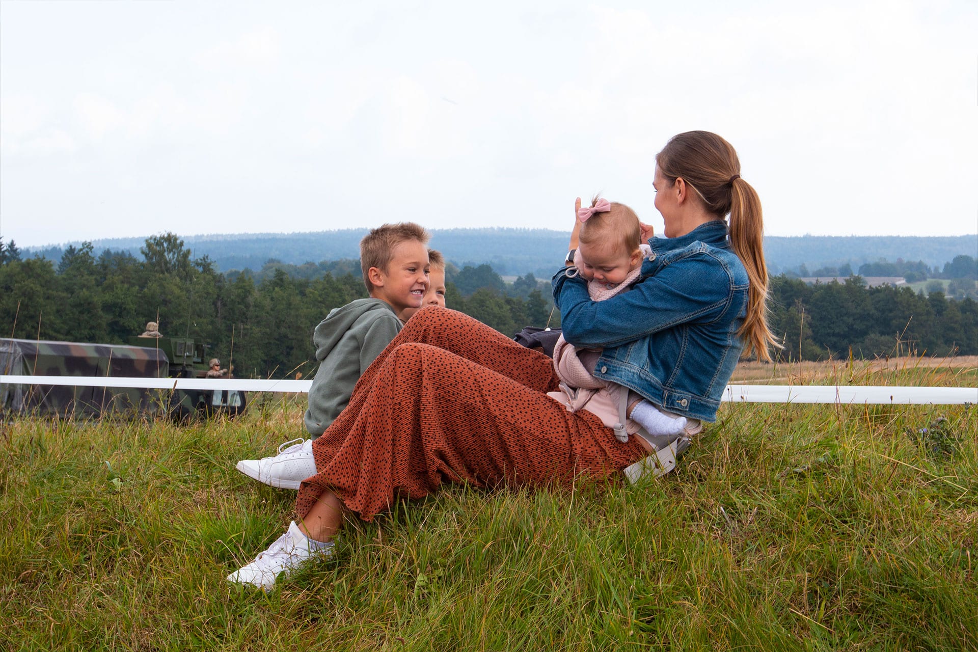 Military Spouse spends time relaxing in the grass with her children